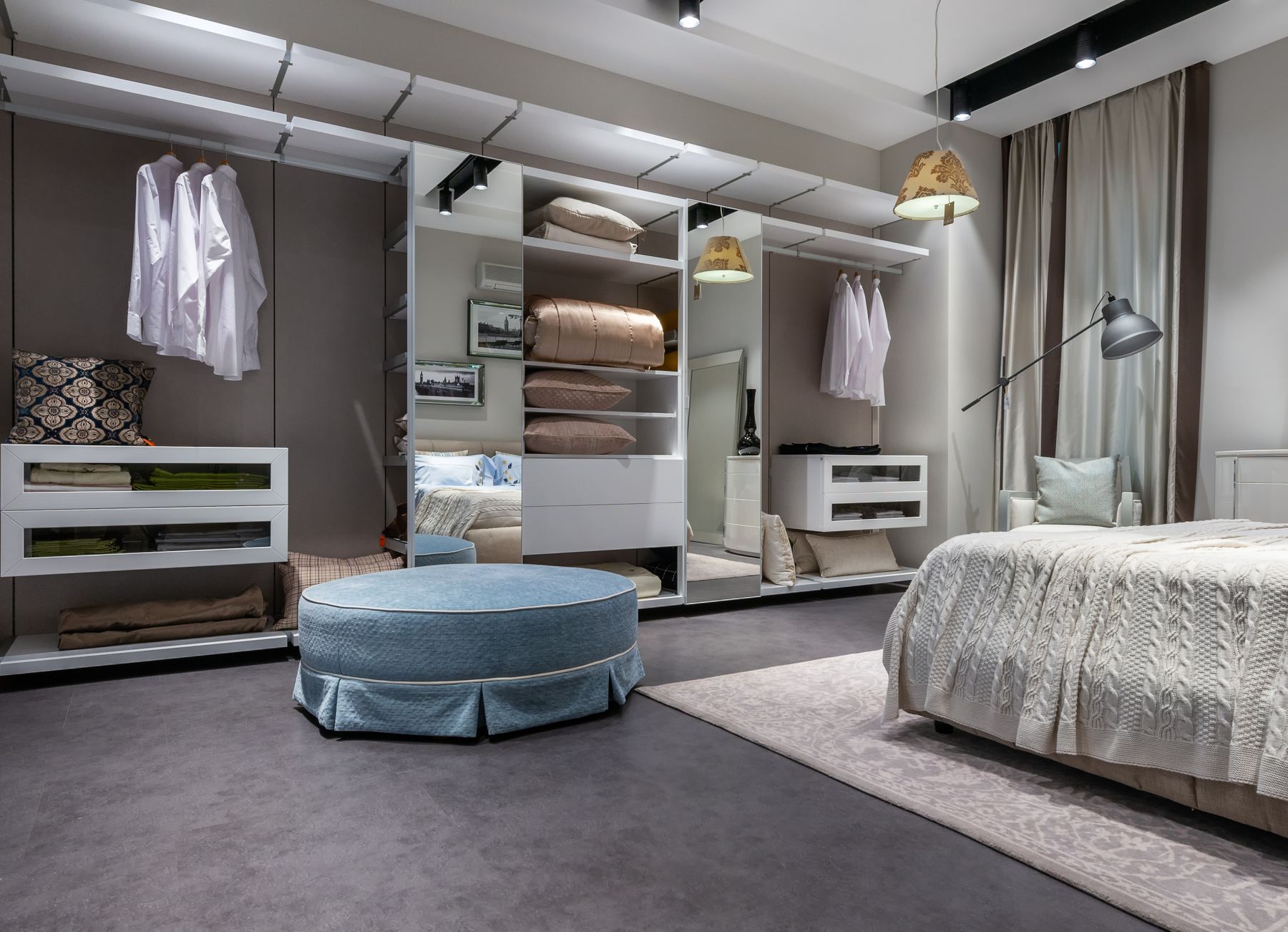 Bedroom with built-in wardrobe and a padded stool