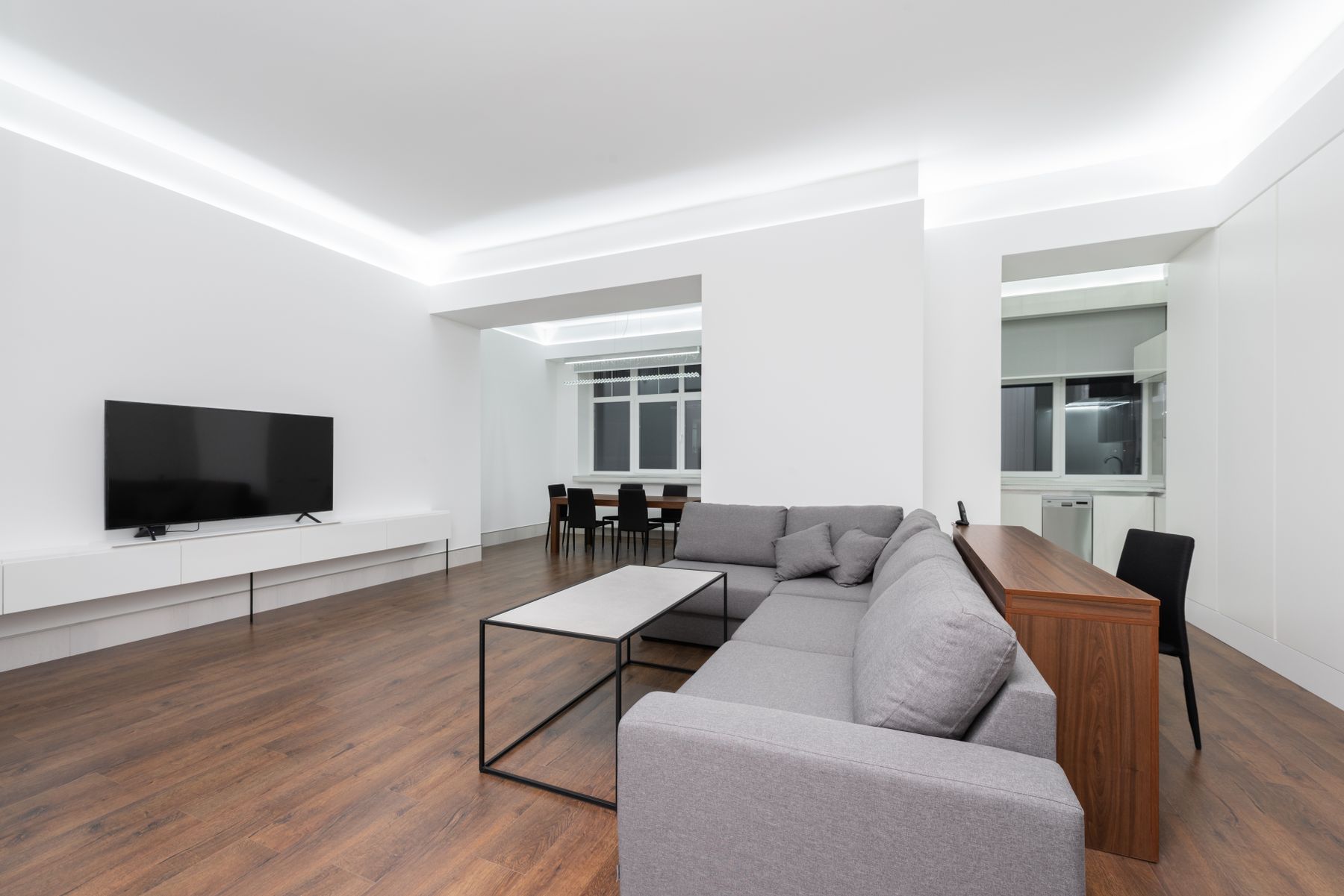 Living area with a designed ceiling and recessed lighting